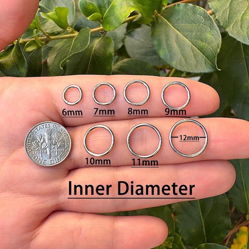 May include: A hand displays several silver jump rings with inner diameters from 6mm to 12mm. A UK coin is included for size comparison. The text "Inner Diameter" is below the rings.