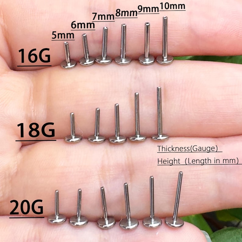 May include: A collection of silver-colored lip piercing studs in various sizes. The image shows studs labeled 16G, 18G, and 20G, with lengths ranging from 5mm to 10mm. The text indicates the thickness (gauge) and height (length in mm).