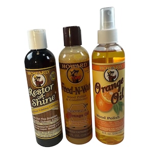 May include: Three bottles of Howard wood care products. The bottles include Restor-A-Shine, Feed-N-Wax, and Orange Oil. Each bottle has a label with the Howard logo and product information. Each bottle contains 8 fl oz (236 mL).