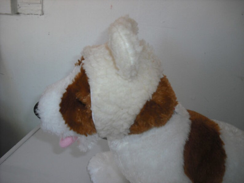 May include: White plush dog toy with brown patches and a white plush hat with floppy ears.
