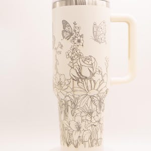Butterfly and flowers laser-engraved 40oz Stainless Steel Insulated Tumbler with custom name.