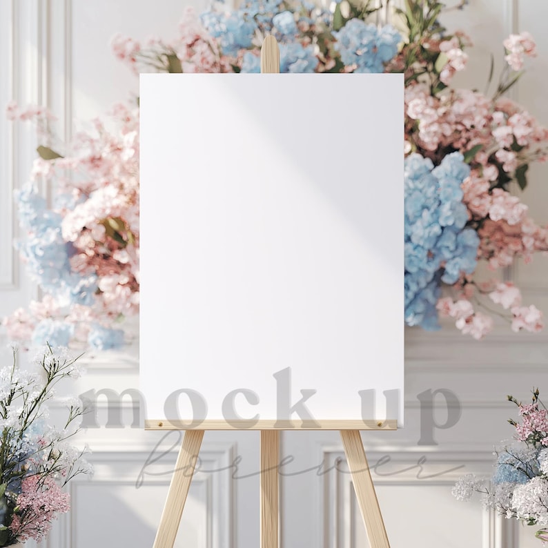 May include: A white canvas on an easel with a wooden frame, surrounded by pink and blue flowers. The canvas is blank and ready for a sign or artwork.
