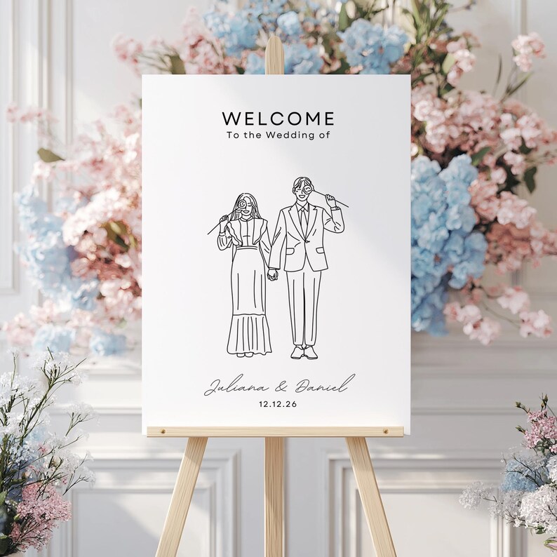 May include: A white welcome sign with black text and a line drawing of a couple. The text reads "Welcome to the Wedding of Juliana & Daniel 12.12.26".