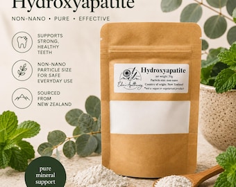 May include: A brown paper pouch of Hydroxyapatite powder with a white label reading Eden's Apothecary, net weight 50g, and non-nano particle size. A small wooden spoon holds a portion of the white powder next to the pouch on a textured surface.
