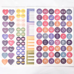 May include: A sheet of colorful stickers with various icons and designs. The stickers include hearts, numbers, days of the week, and icons for exercise, food, and other activities. The stickers are perfect for organizing and decorating planners, journals, and other items.
