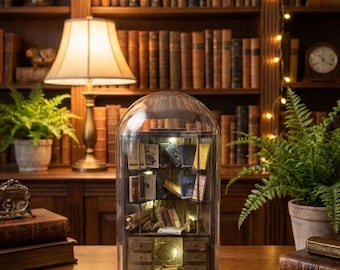 Miniature library with LED lighting inside a glass dome. Tabletop accessory figure.