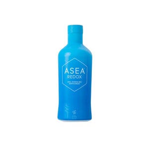 May include: A tall, bright blue bottle with a white label featuring the text "ASEA REDOX CELL SIGNALING SUPPLEMENT". The bottle has a sleek, modern design and is filled with a clear liquid. The bottle is standing upright against a white background.