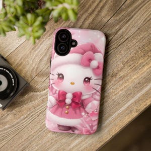 May include: Pink phone case featuring a cartoon character in a pink outfit and hat with a bow. The case has a glossy finish and a camera cutout. The background is a light pink with stars and hearts.