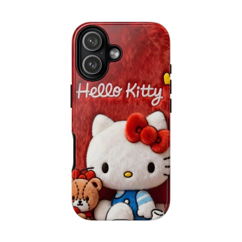 May include: Red phone case featuring Hello Kitty and a teddy bear. The case has a fuzzy texture and the words "Hello Kitty" in white script. Hello Kitty is wearing a red bow and blue overalls.