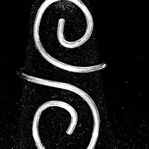 May include: A silver wire wrapped in a smooth, round single wrap design. The wire is twisted into two loops, one on top of the other.