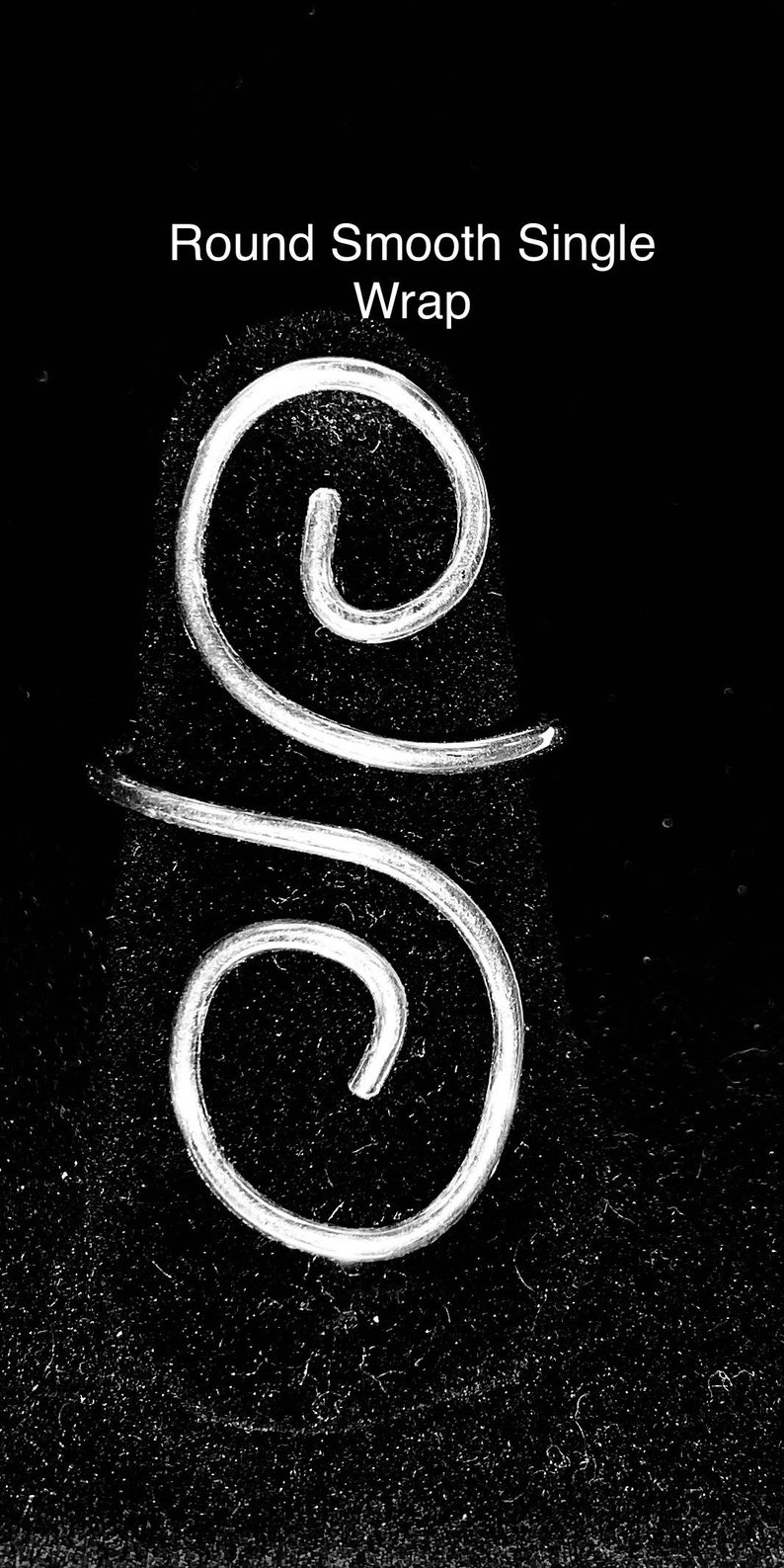 May include: A silver wire wrapped in a smooth, round single wrap design. The wire is twisted into two loops, one on top of the other.