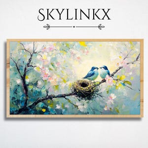 May include: A framed painting featuring two blue birds perched on a tree branch with a nest. The artwork has a light color palette with pink blossoms and the text "SKYLINKX" at the top.