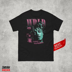 May include: Black t-shirt with a pink and green graphic of rapper Juice Wrld. The graphic includes the text "WRLD", "Juice", "good riddance", and "ecadlove n".