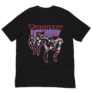 May include: Black t-shirt featuring the band name "Thin Lizzy" in red and blue lettering. Below the text is a graphic of four band members in motion, outlined in black and white.