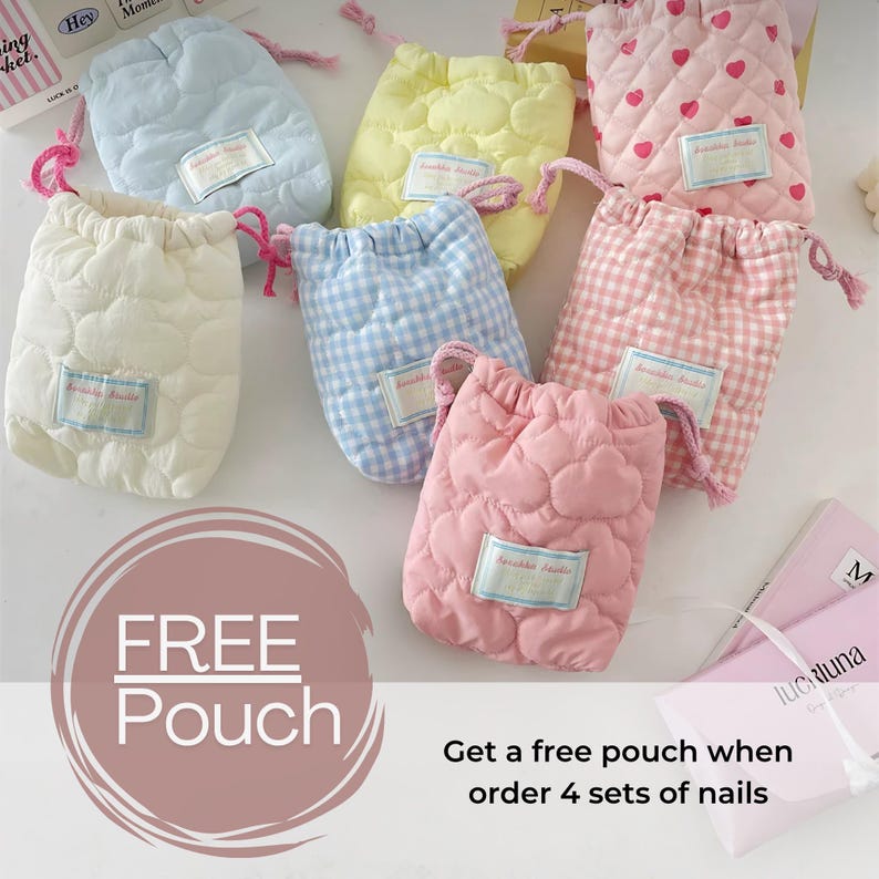 May include: A collection of quilted drawstring pouches in various pastel colors, including white, blue, yellow, and pink. Some pouches feature heart or gingham patterns. Each pouch has a small label and a pink drawstring. The image also includes text that says "FREE Pouch".