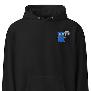 Pode incluir: Moletom preto com bolso canguru e capuz com cordão. Um pequeno personagem de desenho animado azul bordado com o texto "I can't C#" está no peito esquerdo. O moletom é feito de um material macio.