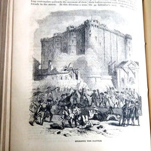 May include: An illustration depicting the storming of the Bastille. The image shows a large fortress under attack by a crowd of people, with soldiers and cannons visible. The text "STORMING THE BASTILE" is at the bottom.