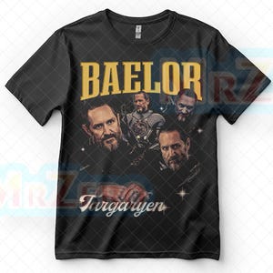 以下が含まれることがあります： 金色の文字で「BAELOR」と書かれた黒いTシャツ。画像のコラージュが特徴です。「Targaryen」の文字が白で下に書かれています。このシャツはクルーネックで半袖です。