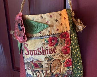26-30 Handmade ditty bag with braided jute shoulder strap embellished with embroidery and floating flower.