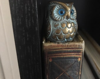 Small patina Brass owl with blue glass eyes