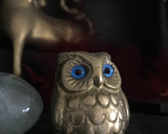 Small polished Brass owl with blue glass eyes