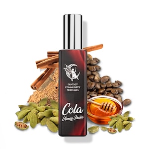 May include: A red and black bottle of perfume with a silver cap. The bottle has a white label with the text "Fantasy Community Perfumes" and "Cola Honey Shake". The bottle is surrounded by coffee beans, cinnamon sticks, and cardamom pods.
