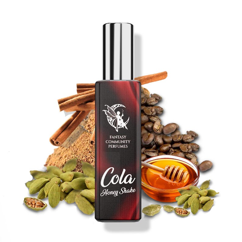 May include: A red and black bottle of perfume with a silver cap. The bottle has a white label with the text "Fantasy Community Perfumes" and "Cola Honey Shake". The bottle is surrounded by coffee beans, cinnamon sticks, and cardamom pods.