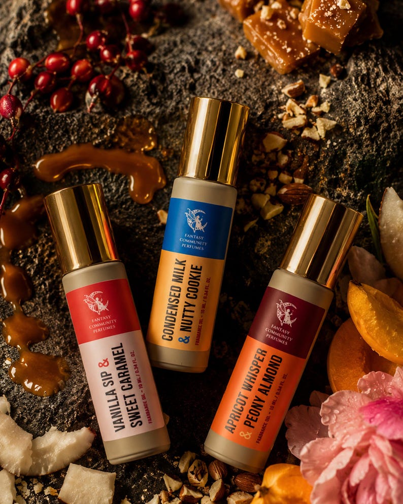 May include: Three fragrance oil bottles with gold caps and labels. The labels read "Vanilla Sip & Sweet Caramel", "Condensed Milk & Nutty Cookie", and "Apricot Whisper & Peony Almond". The bottles are surrounded by nuts, caramel, and fruit.