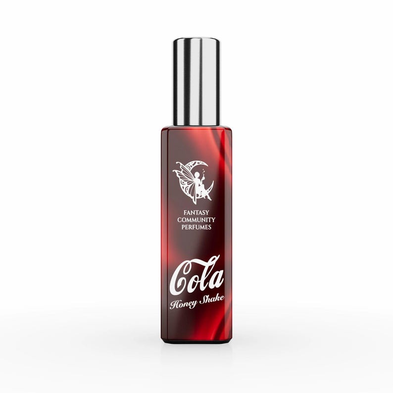May include: A red glass bottle of perfume with a silver cap. The bottle has a white label with the text "Fantasy Community Perfumes" and "Cola Honey Shake".