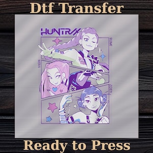May include: A DTF transfer featuring a manga-style illustration of three girls named Mira, Rumi, and Zoey. The image has a purple and white color scheme with the text "HUNTRAX" and "Ready to Press".