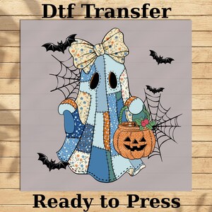 May include: A patchwork ghost design with a floral bow, holding a jack-o'-lantern. The image includes bats and spiderwebs, with the text "Dtf Transfer" and "Ready to Press". The design is perfect for Halloween.
