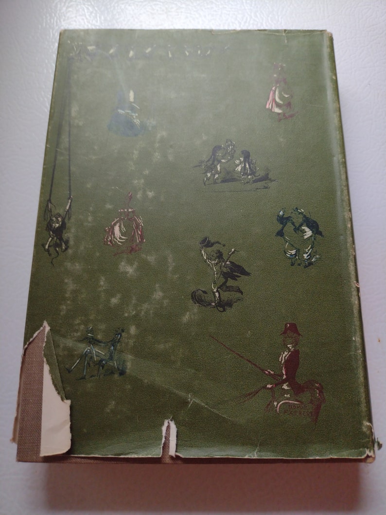 May include: Vintage book cover with a distressed green background and whimsical illustrations in black and red. The cover features various figures, including people on swings and in carriages, with some damage to the edges.