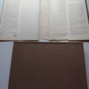 May include: An open book with a brown cover and pages. The left page has text about Charles Dickens and Early Victorian England. The right page has text about Cicero and the Roman Republic.