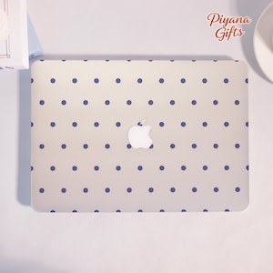 May include: A laptop skin featuring a repeating pattern of small dark blue polka dots on a light beige background. The skin is applied to a laptop with a centered white Apple logo. The text "Piyana Gifts" is printed in brown in the upper right corner.