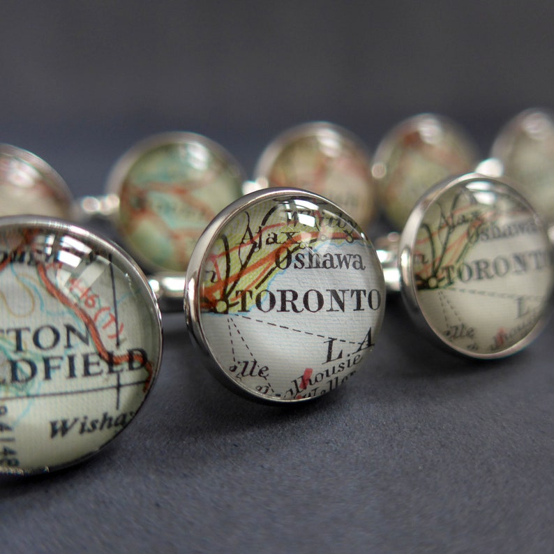 Multiple sets of Silver Plated Map Cuff Links customised with placenames using vintage maps