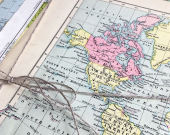 May include: A vintage world map with a light blue background, showing the continents of North America, South America, and parts of Europe and Africa. The map is printed in black and yellow with pink and light blue accents. The map is labeled with the names of countries and oceans.