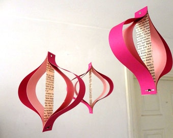 Valentines Day paper decorations, recycled romance novels, retro geometric curves, pink white