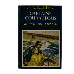 May include: A vintage hardcover book titled "Captains Courageous" by Rudyard Kipling. The cover features an illustration of two figures on a ship at sea. The book's title and author are in white text against a dark blue background.