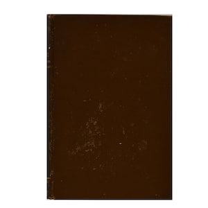 May include: A rectangular, brown book with a slightly distressed cover. The book's spine is visible on the left side, and the cover has a matte finish. The overall aesthetic suggests a vintage or antique item.