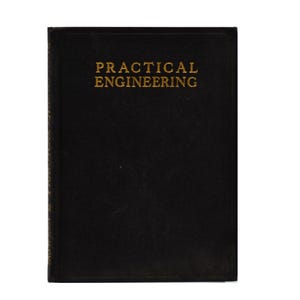May include: A black book with the title "PRACTICAL ENGINEERING" in gold lettering. The book has a simple, classic design, with a solid black cover and a clean, minimalist aesthetic. The book is likely a technical manual or textbook.