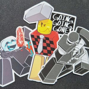 May include: A collection of cartoon character stickers. The stickers feature various characters with block-shaped bodies and faces, including one with a yellow face and a red and black checkered body. One sticker has the text "GOING GOING GONE".