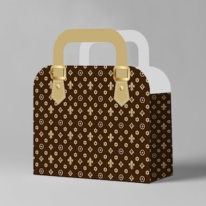 May include: A brown and gold patterned handbag with a gold handle and gold buckles. The bag features a repeating pattern of fleur-de-lis and circular shapes. The handle and buckle straps are a lighter shade of gold.