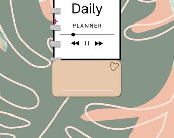 May include: A white planner with the text "2025 Daily Planner" and a music player icon. The planner is on a background of green and pink leaves.