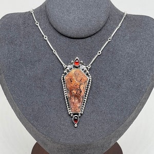 coffin pendant accented with garnet