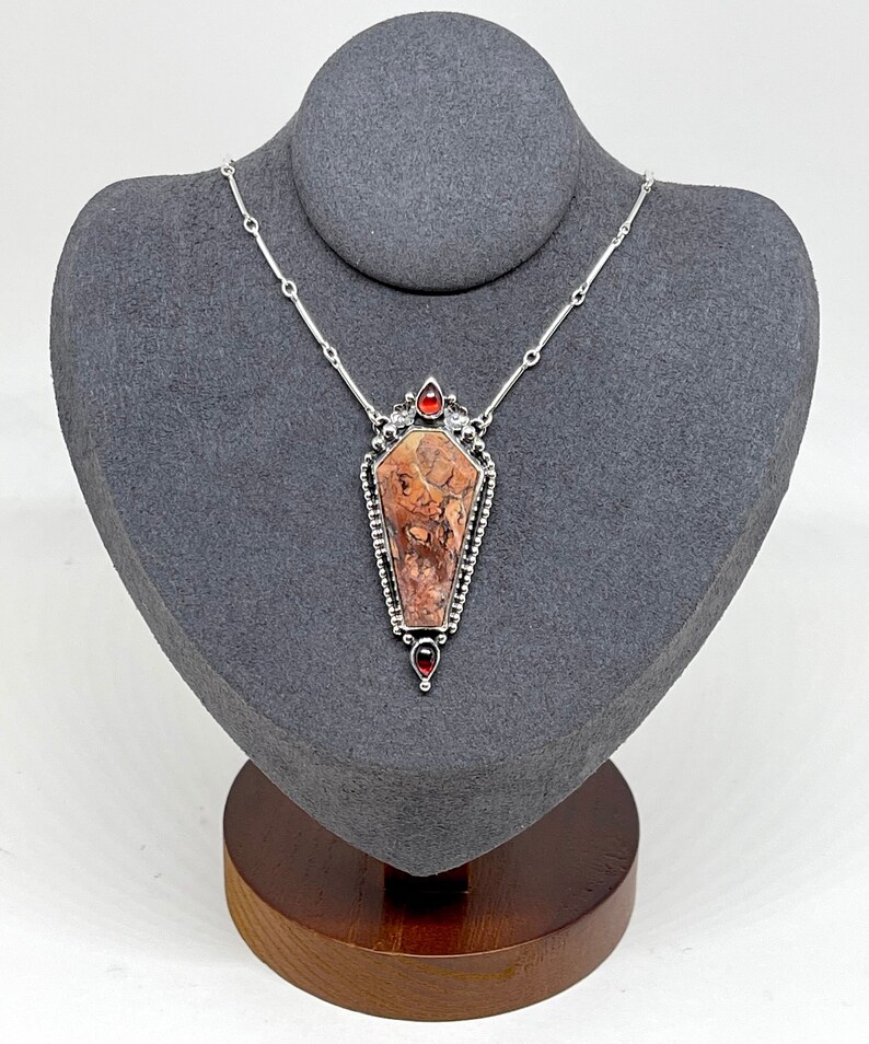 coffin pendant accented with garnet