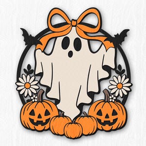 May include: A layered wooden wall decoration featuring a central cream-coloured ghost with an orange bow on its head, framed by a black circular border. The design includes two jack-o'-lanterns, three smaller pumpkins, two white flowers, and two black bats.