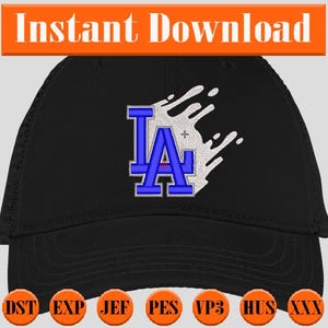 Puede incluir: Gorra de béisbol negra con un diseño de salpicaduras de pintura blanca y bordado azul "LA".