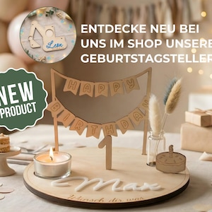 May include: A wooden birthday cake topper with a banner that reads "Happy Birthday". The number "1" is also included. A small lit candle and a miniature cake are on the wooden base. The text "Max" is also on the base.