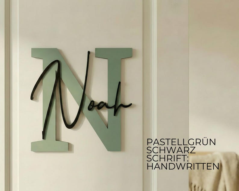 May include: A wall-mounted wooden sign featuring the name "Noah" in a cursive font over a large letter "N". The letter "N" is a pastel green color, and the name "Noah" is black. The sign is mounted on a light-colored wall.