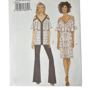 May include: A Very Easy Vogue sewing pattern, V9238, featuring illustrations of two different outfits. The pattern includes a top with flared sleeves and pants, and a floral print dress. The size range is (14-16-18-20-22).